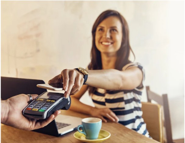 Customer paying with a debit card at a card reader